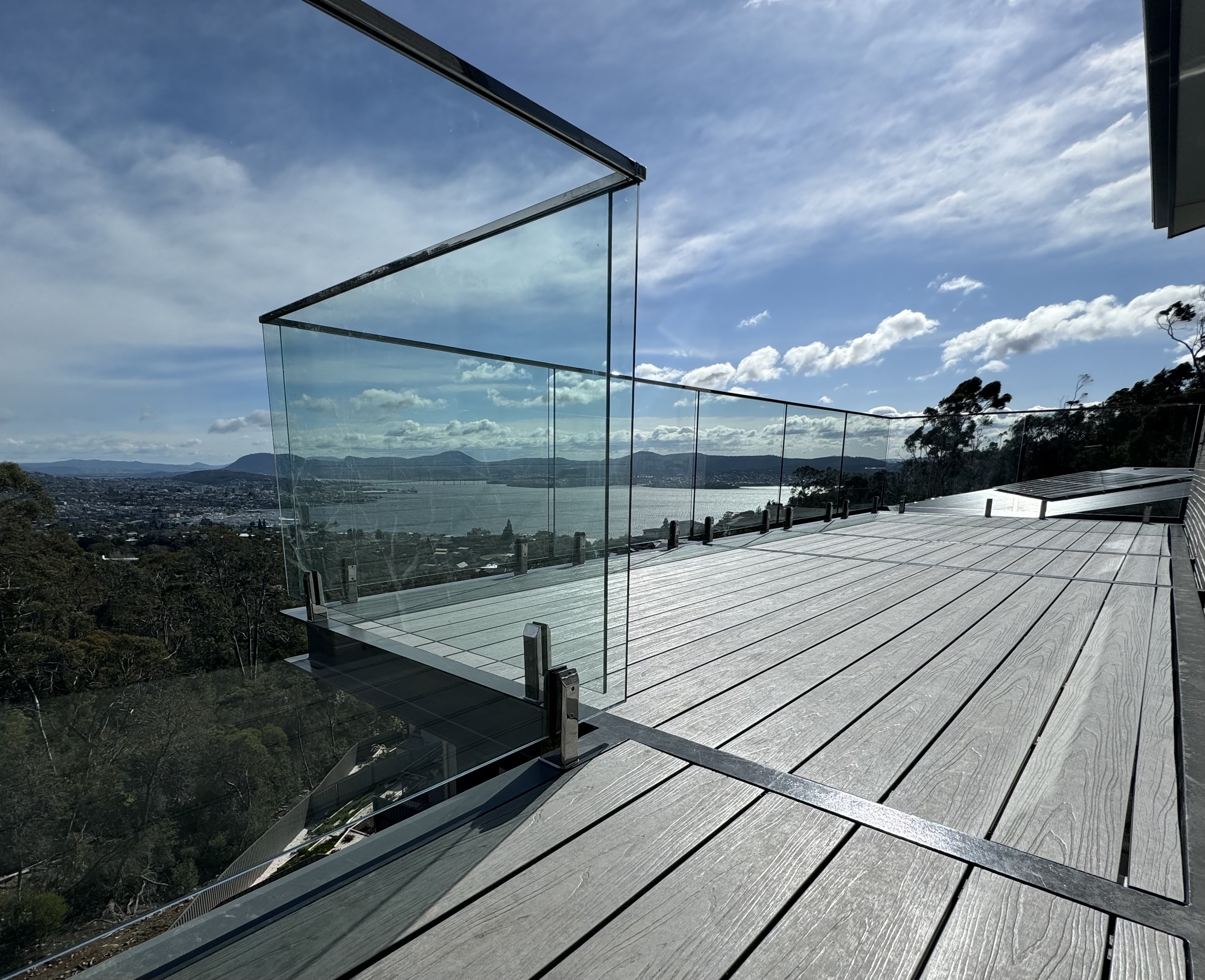 Glass balustrade on a timber deck overlooking the countryside